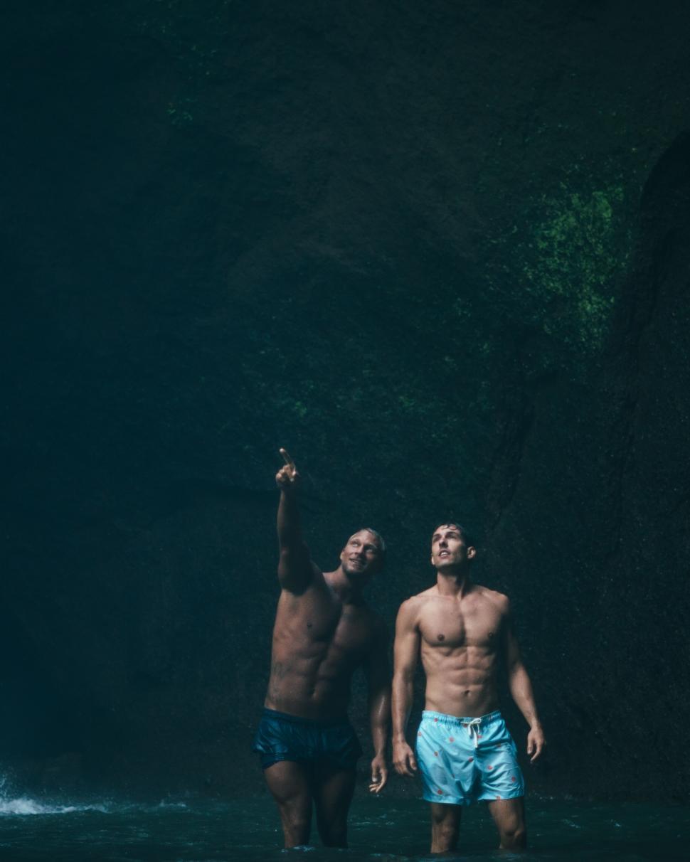 Free Image of Two men looking up in a cave 