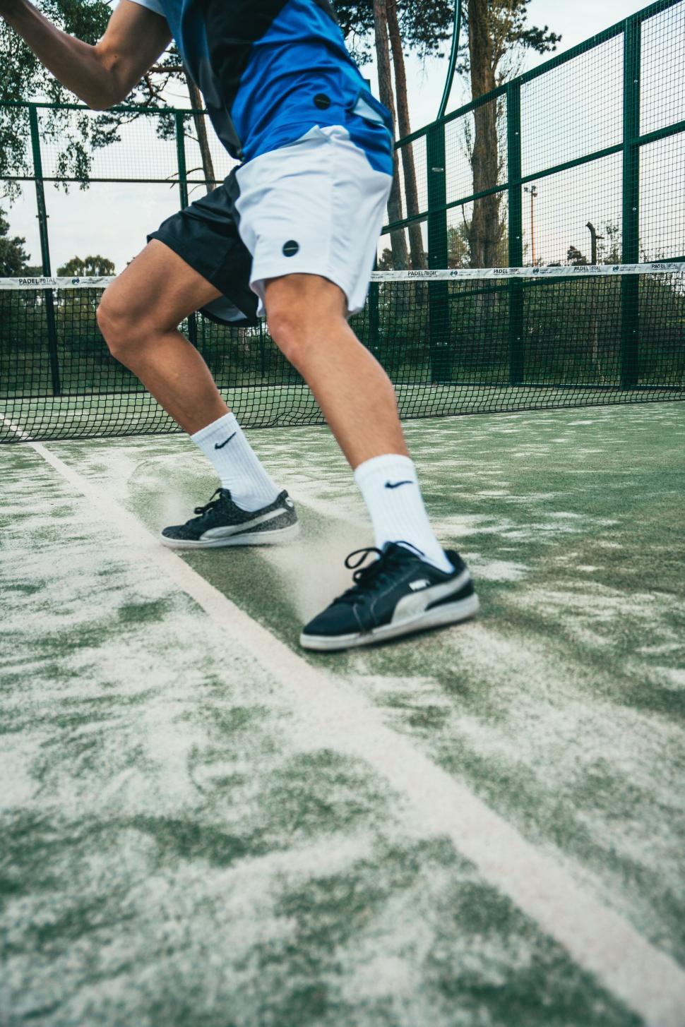 Free Image of Athletic moment on a tennis court 