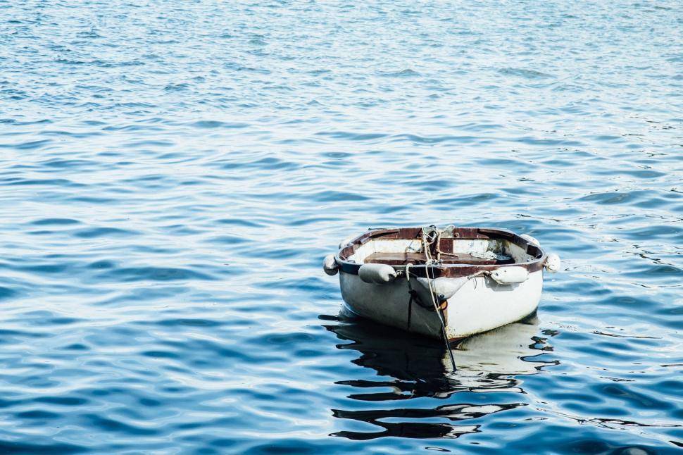 Free Image of A lone boat floating on a calm sea 