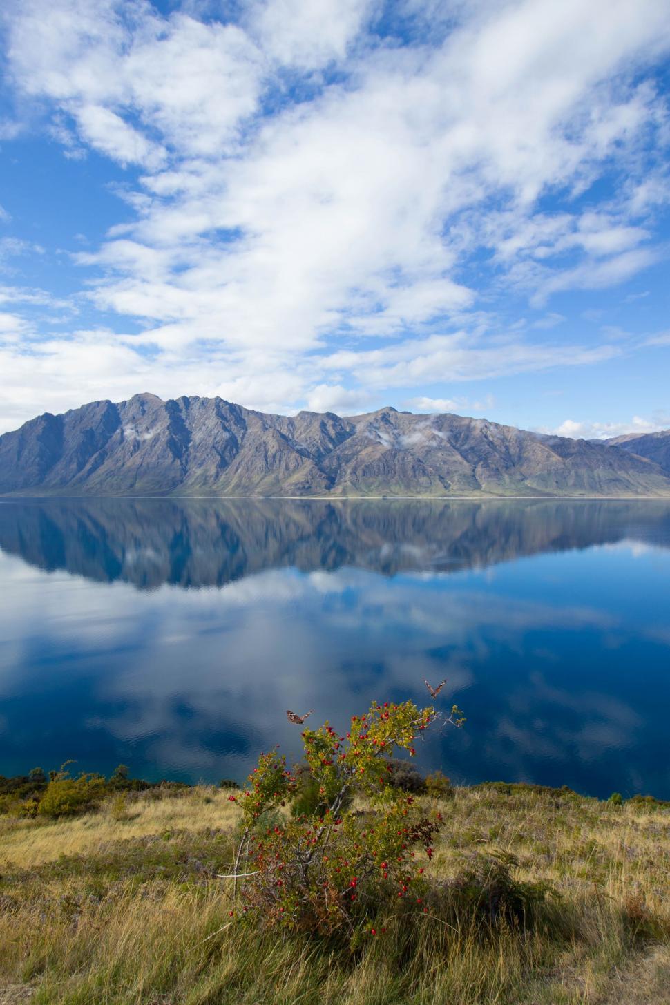 Free Image of Mountain reflection on a clear blue lake 