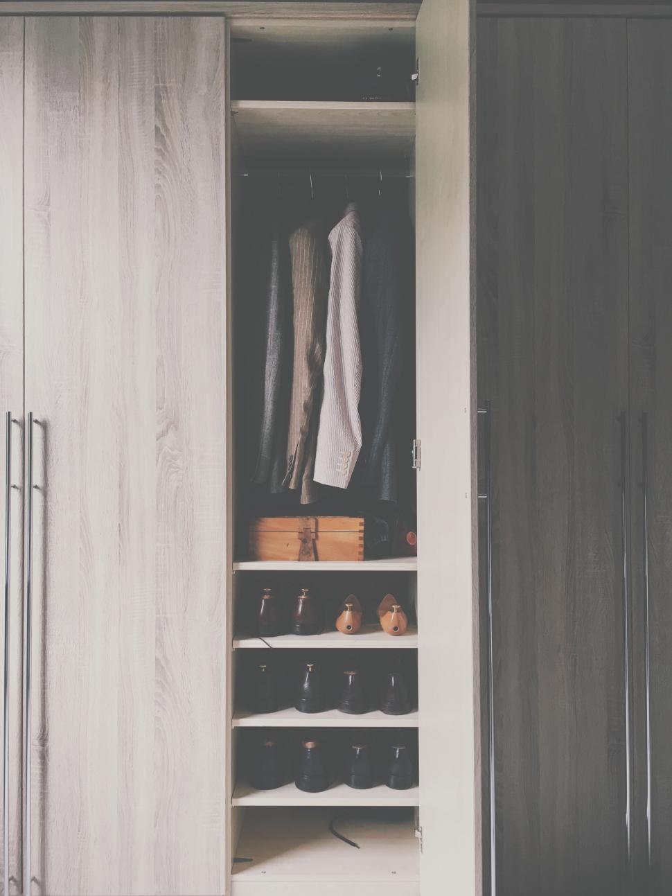 Free Image of Open wardrobe with clothes and shoes neatly arranged 