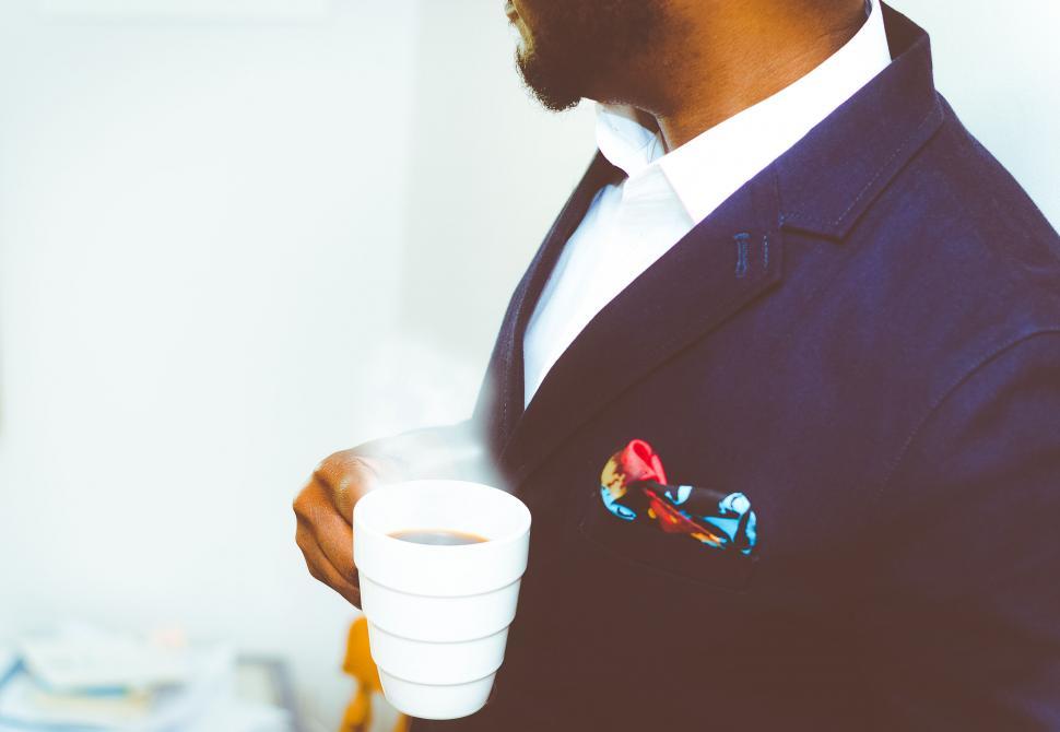 Free Image of Man with a coffee mug in a suit 