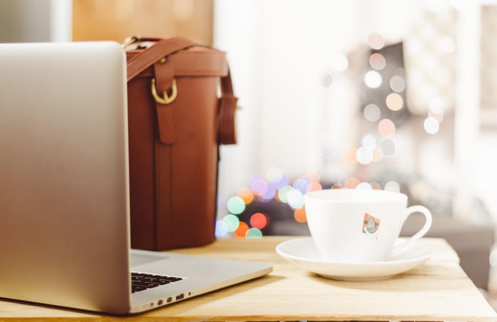 Free Image of Coffee cup and laptop on wooden table 