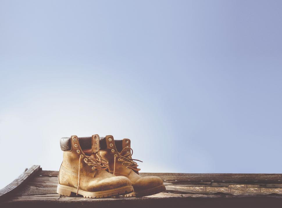 Free Image of Pair of work boots against a sky background 