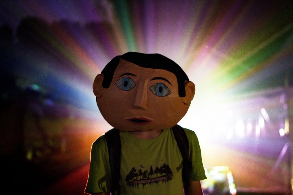 Free Image of Person with cartoon head at a light show 