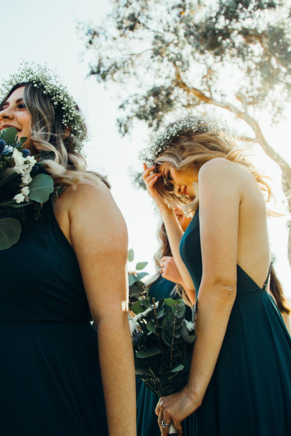 Free Image of Bridesmaids wearing flower crowns in sunlight 
