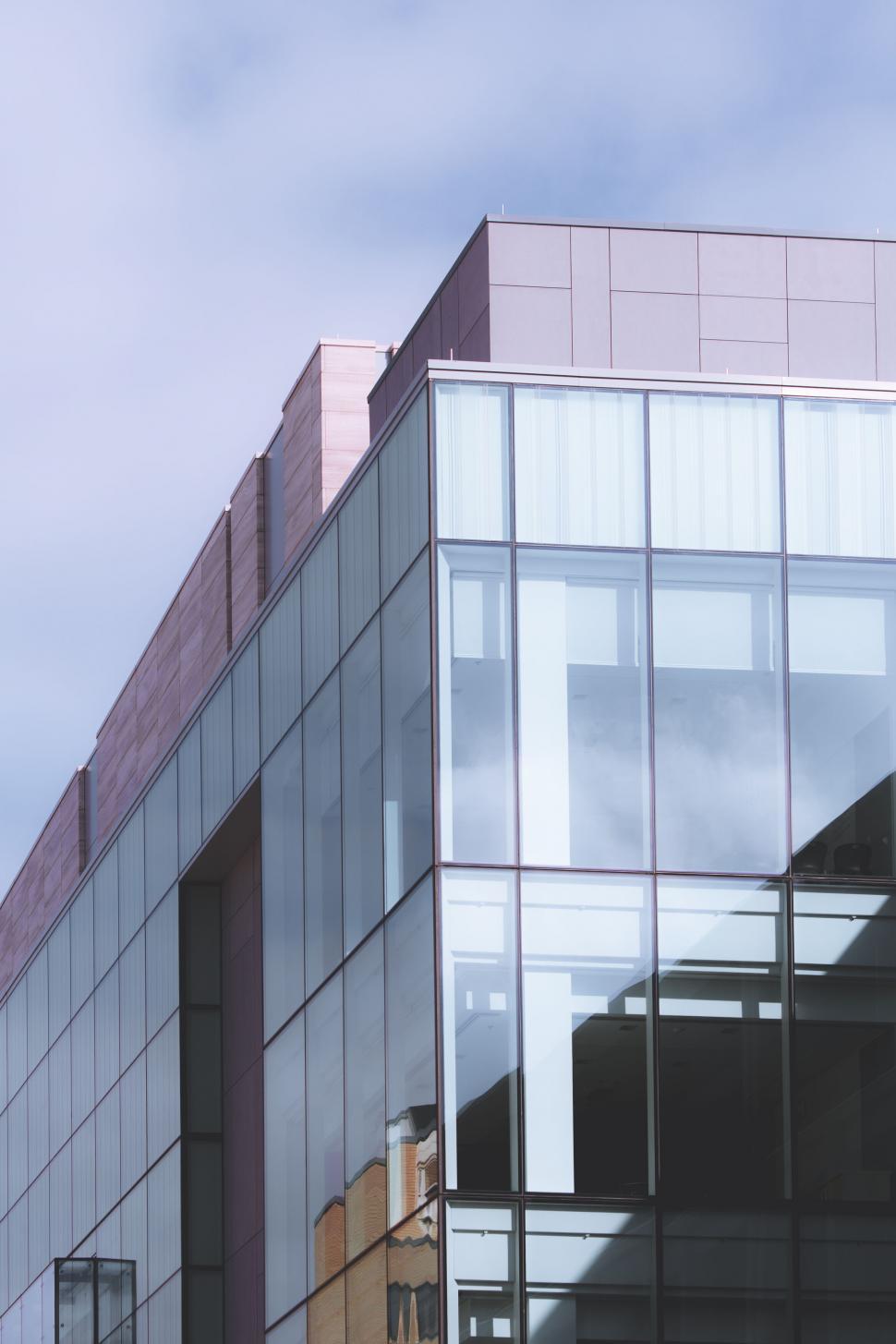 Free Image of Modern glass building with sky reflection 