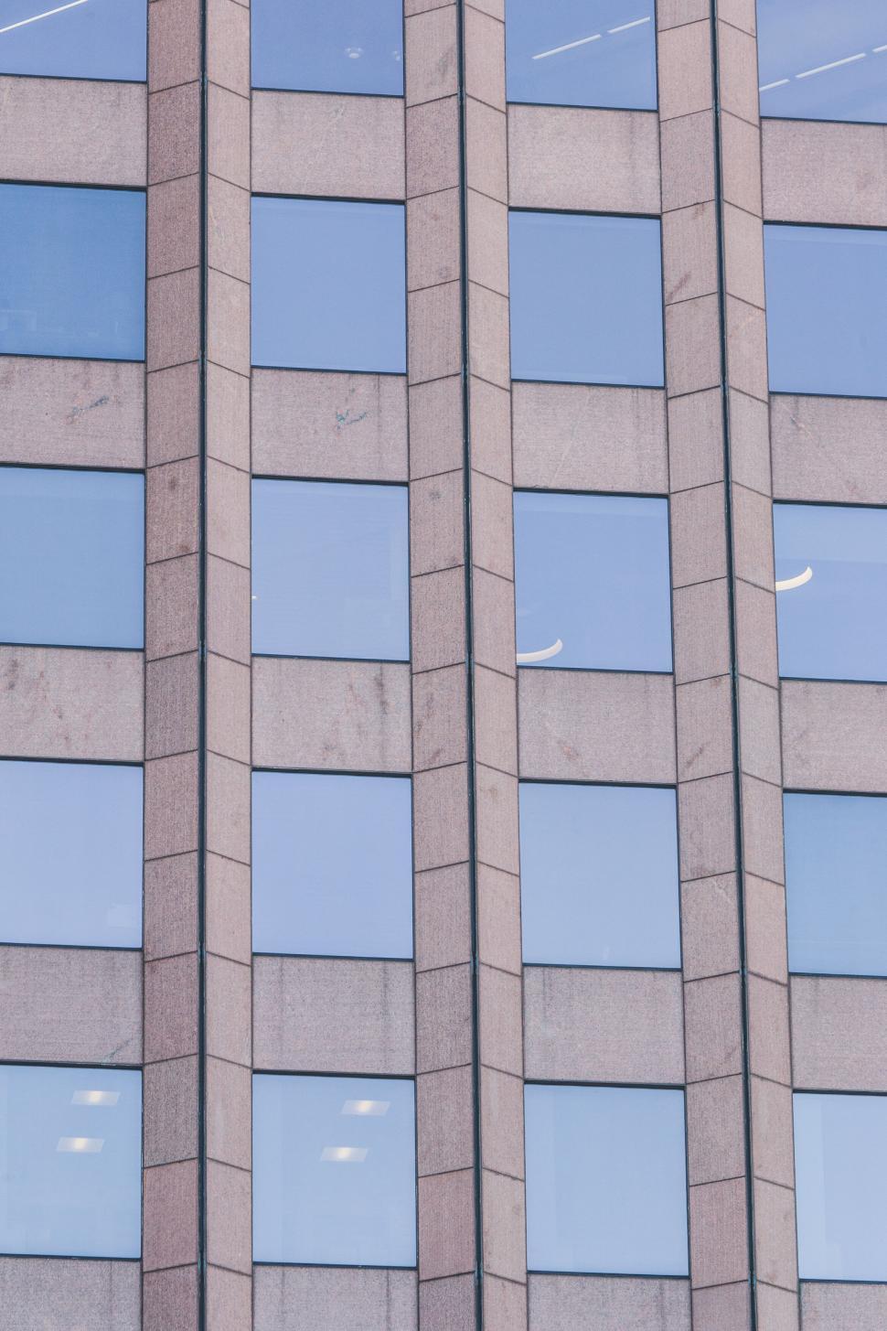 Free Image of Reflections in the windows of a modern building 
