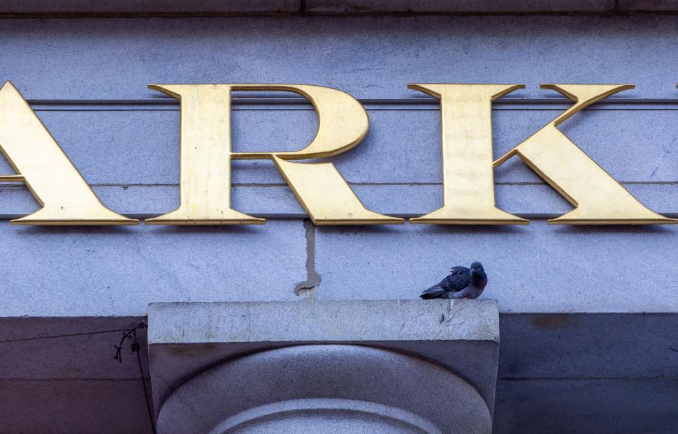 Free Image of Gold  ARK  letters on a building with a pigeon 