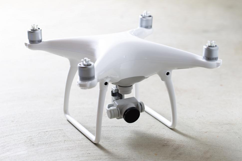 Free Image of White quadcopter drone on a table 