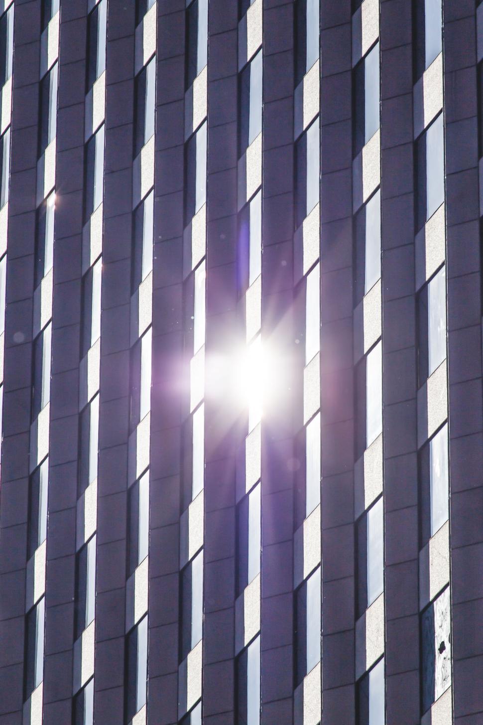 Free Image of Sun flare between the gaps of skyscraper 