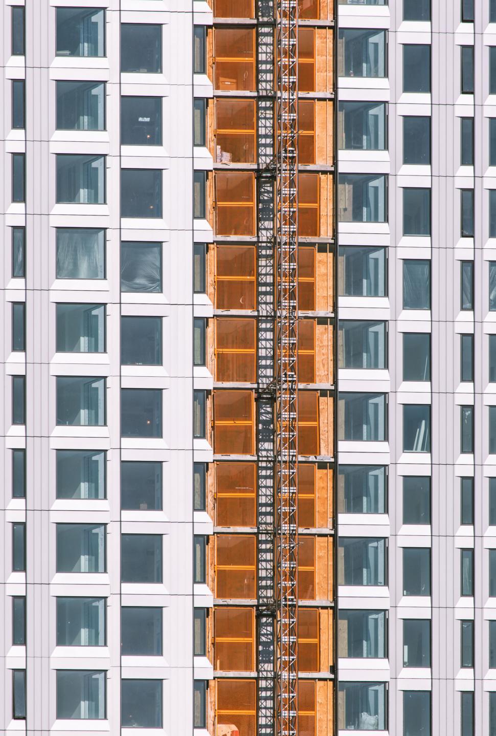Free Image of Close-up of towering building with scaffolding 