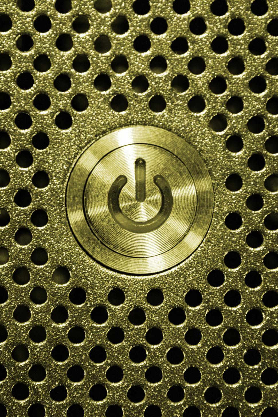 Free Image of Golden power button on metal surface 