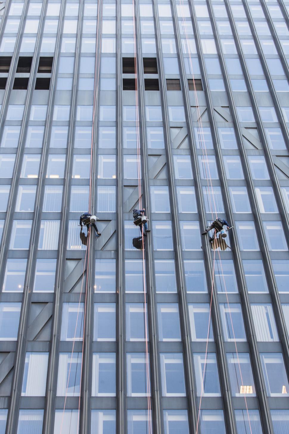 Free Image of Window cleaners working on a skyscraper 
