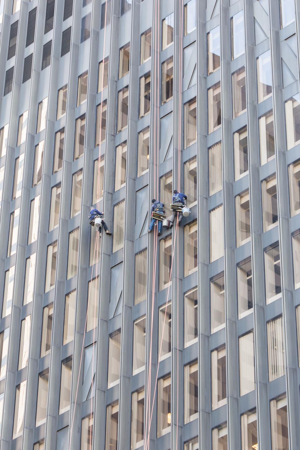 Free Image of Window cleaners working on a skyscraper 