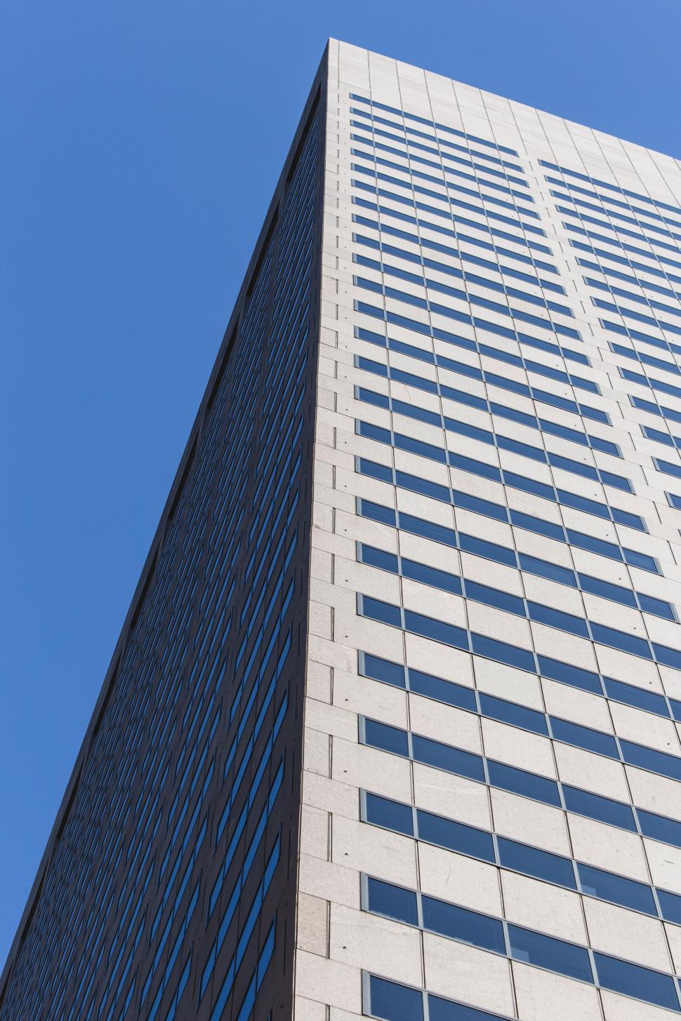 Free Image of Looking up at tall building with blue sky 