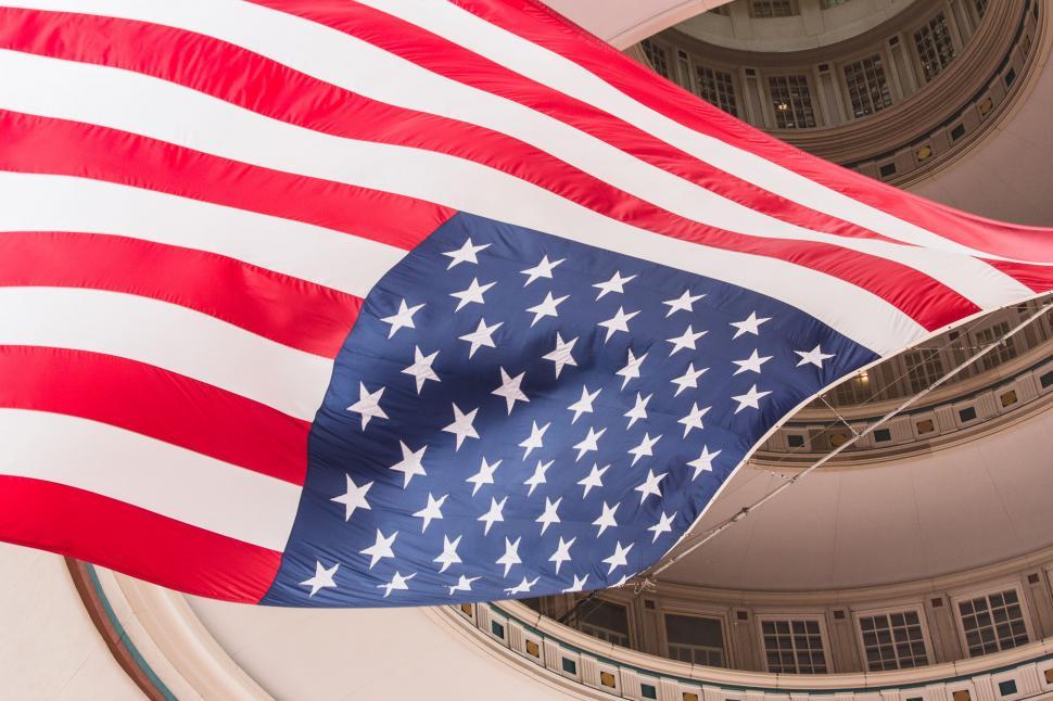 Free Image of American flag waving against historic building 