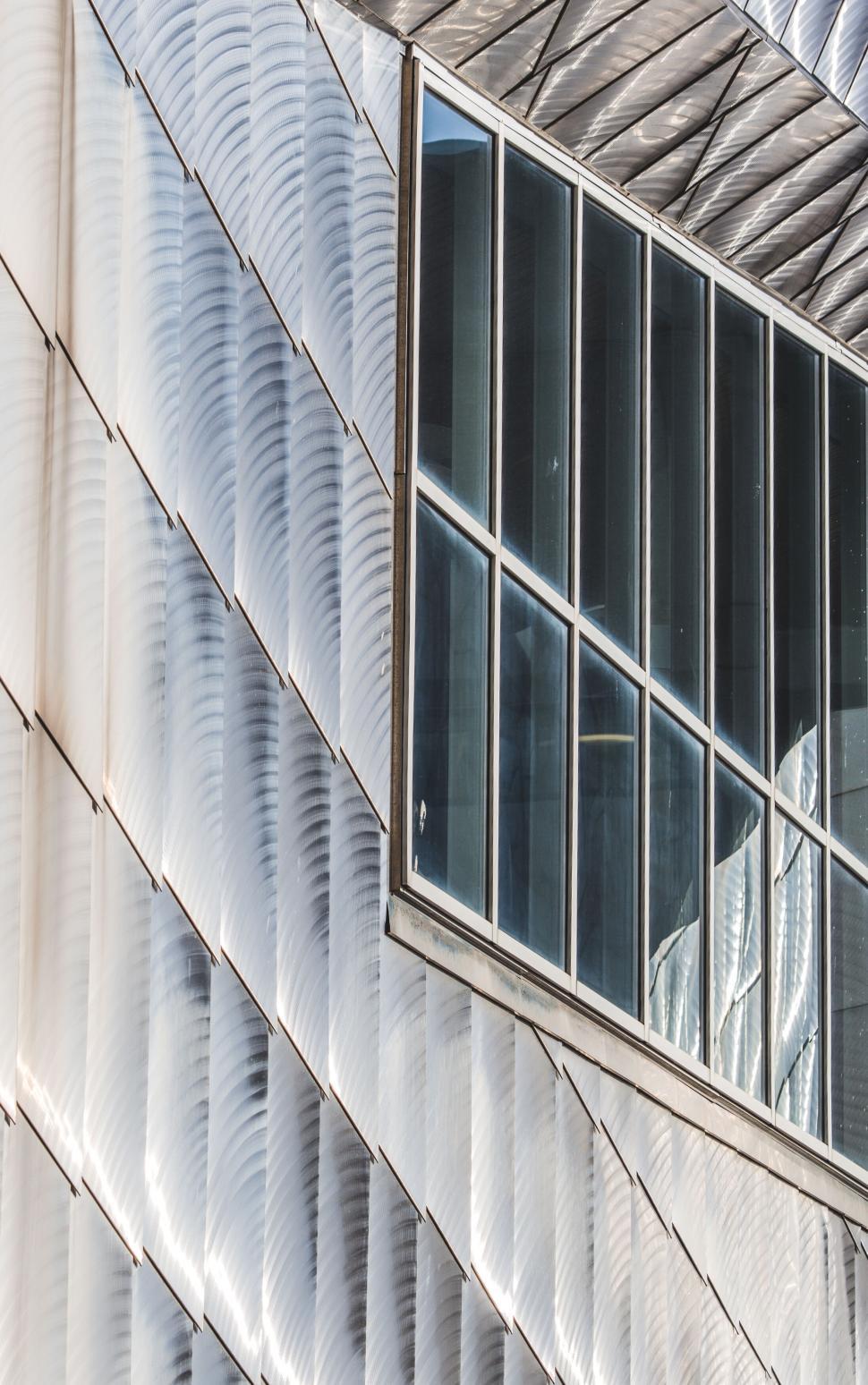 Free Image of Curved modern building with reflective glass windows 