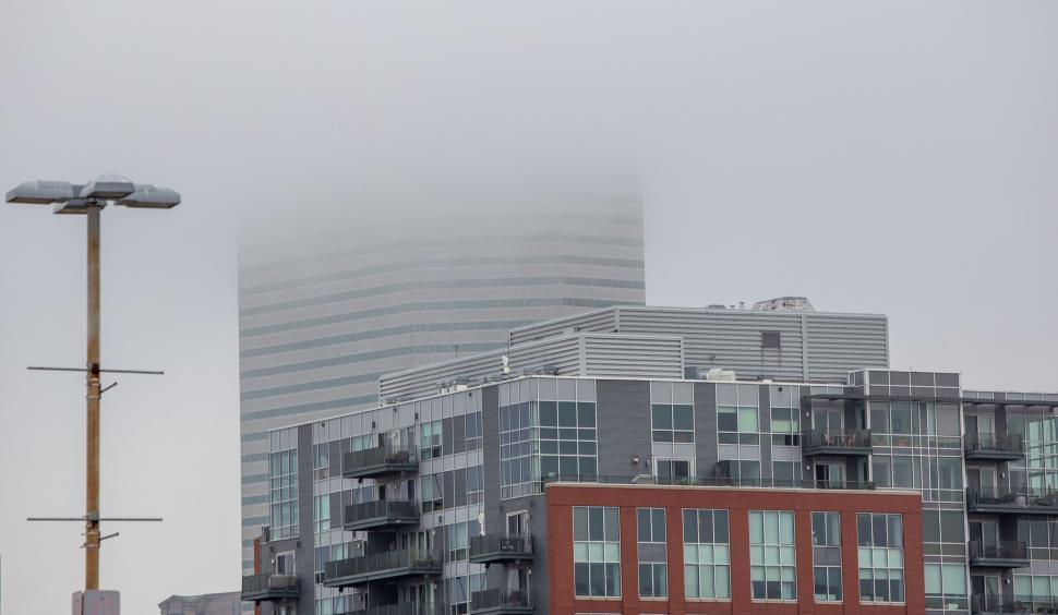 Free Image of Foggy cityscape with buildings partially obscured 