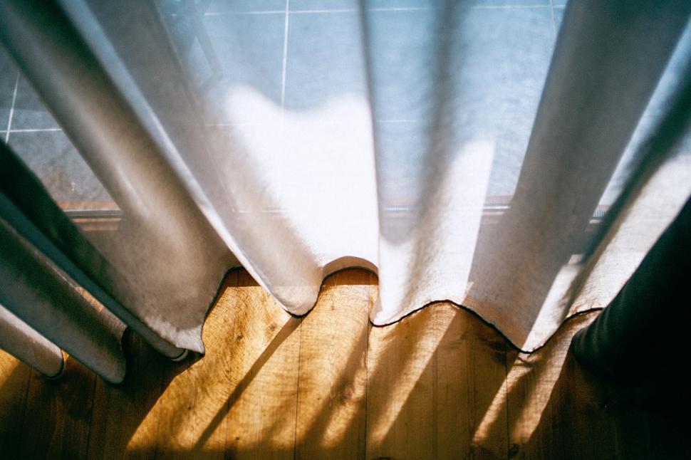 Free Image of Sunlight filtering through white curtains 