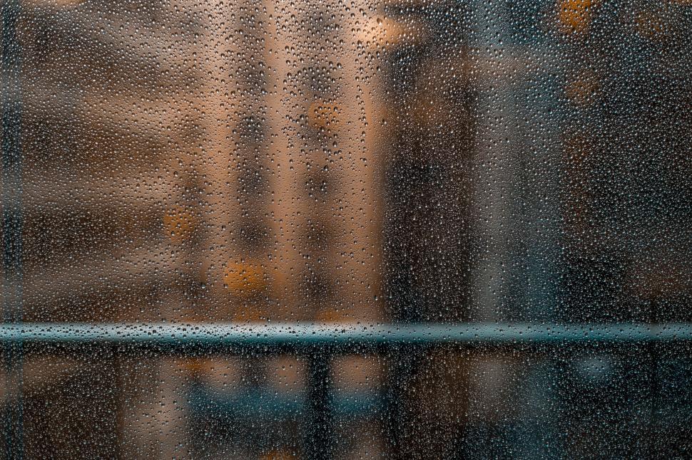 Free Image of Raindrops on window overlooking cityscape 