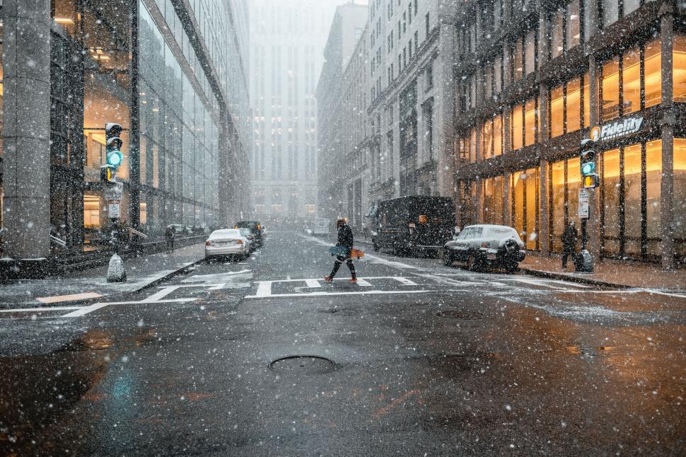 Free Image of Snowy city street with a pedestrian 
