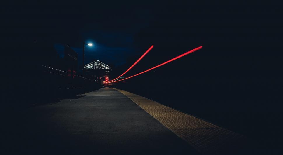 Free Image of Train platform with light streaks at night 