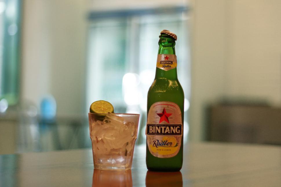 Free Image of Bottle and glass of Bintang beer on a table 