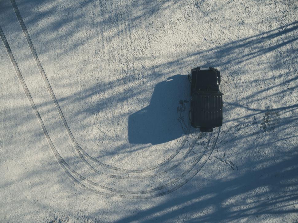 Free Image of Jeep and its shadow on snowy track 