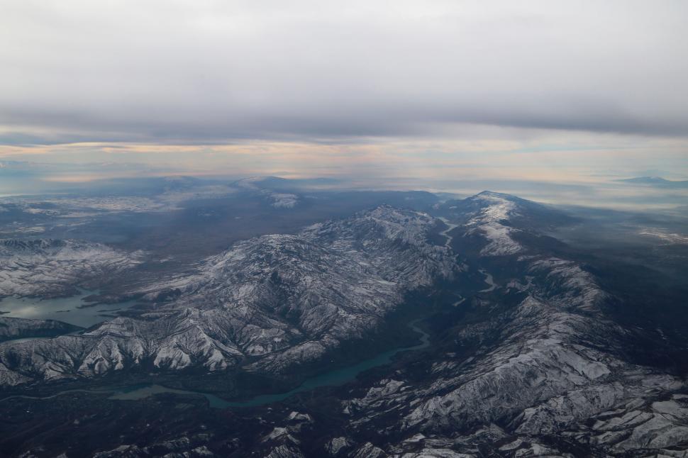 Free Image of Aerial view of snowy mountains and green lake 