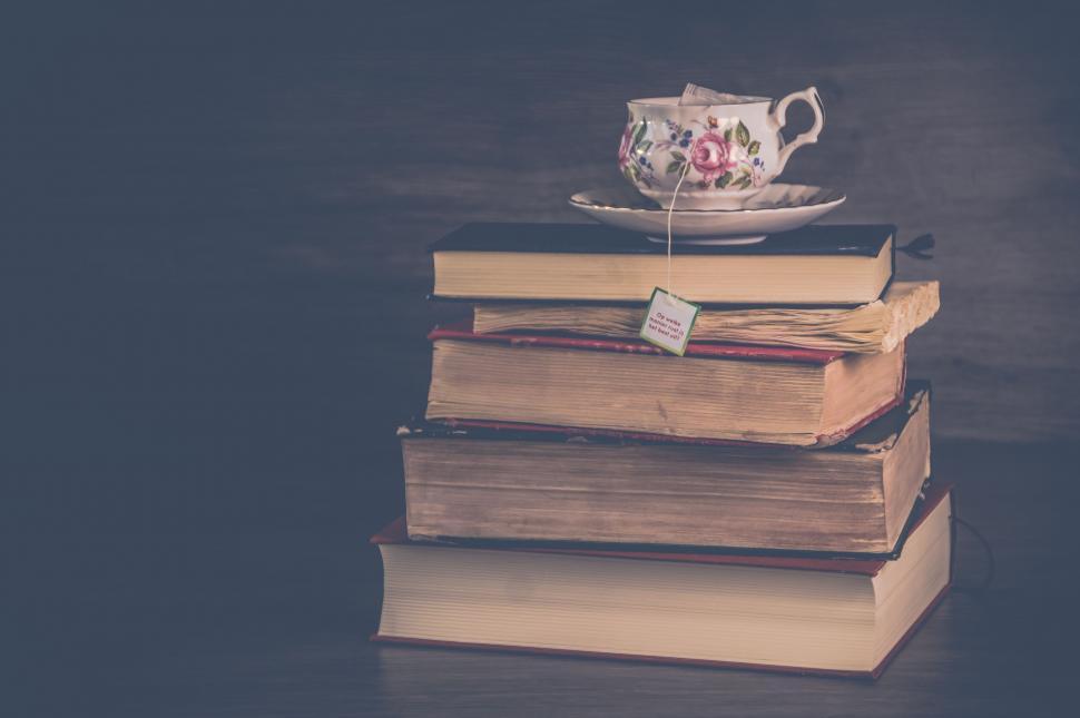 Free Image of Vintage teacup stacked on old books 