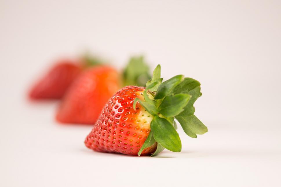 Free Image of Close-up of strawberries with a white backdrop 