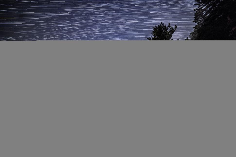Free Image of Star trails over tranquil night landscape 
