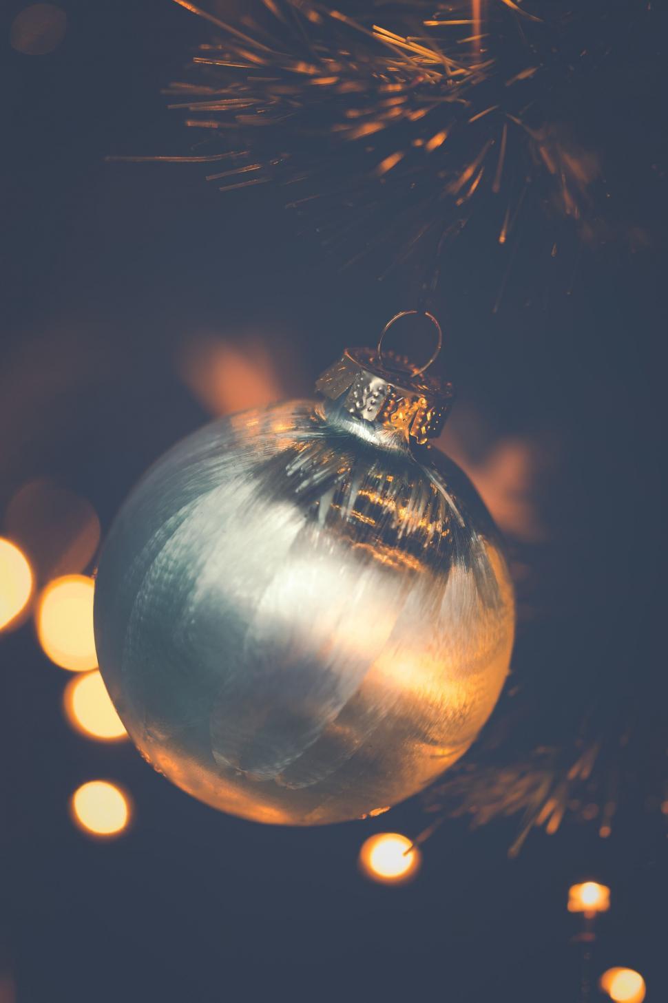 Free Image of Christmas bauble on a twinkling tree 