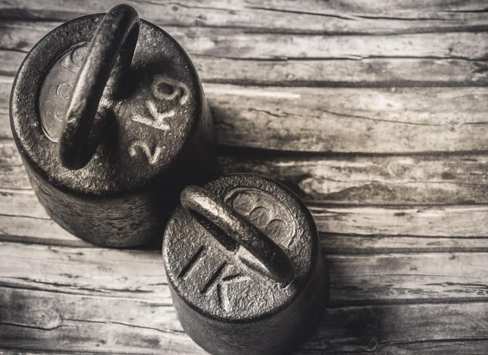 Free Image of Antique weights on wooden surface 