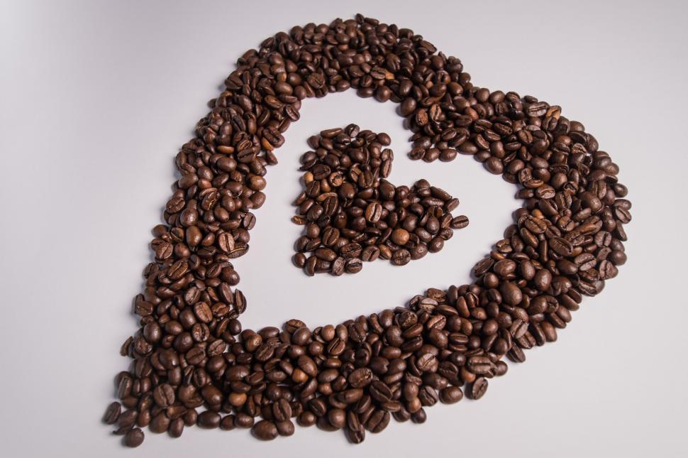 Free Image of Coffee beans forming an  symbol on white 