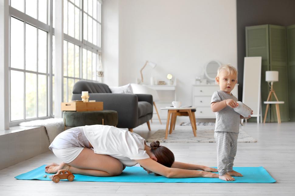 Free Image of Toddler near mother practicing yoga pose 