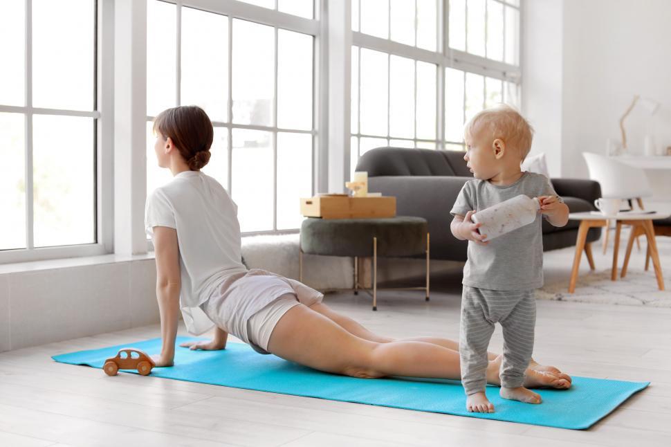 Free Image of Child watching mother during her yoga workout 