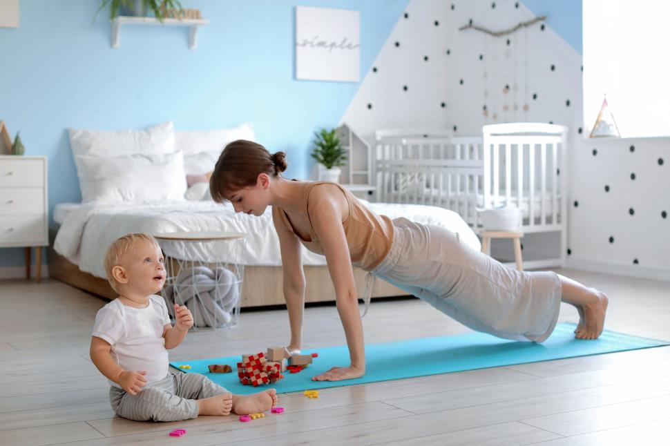 Free Image of Mother engaging with toddler during exercise 