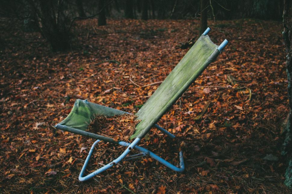 Free Image of Abandoned green canvas chair in a forest 