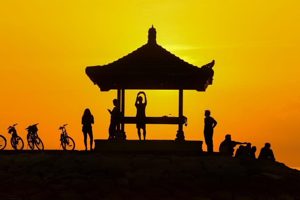 Free Image of Silhouetted people and structure at sunset 