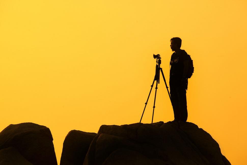 Free Image of Silhouette of a photographer at sunset 
