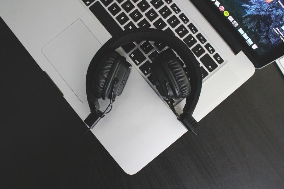 Free Image of Black headphones on a laptop keyboard 