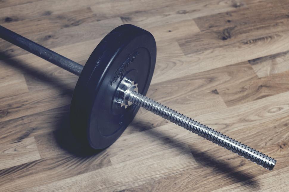 Free Image of Barbell on wooden floor in gym setting 