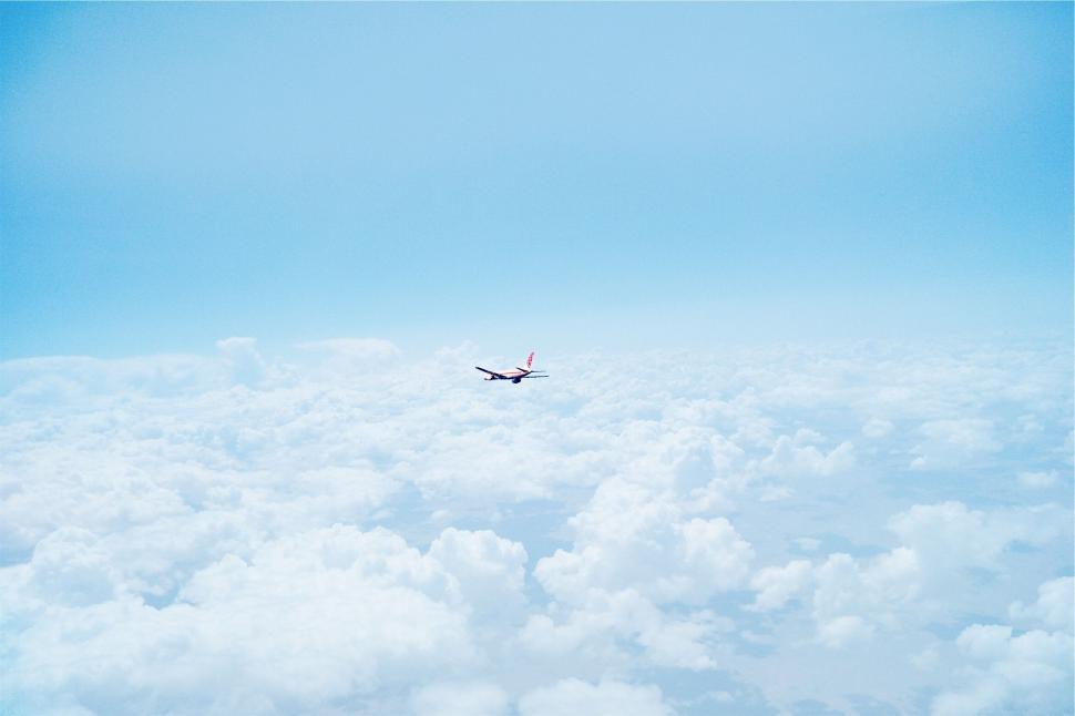 Free Image of Airplane flying through cloudscape 