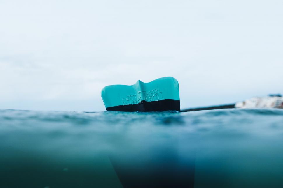 Free Image of Surfboard tail floating on ocean surface 