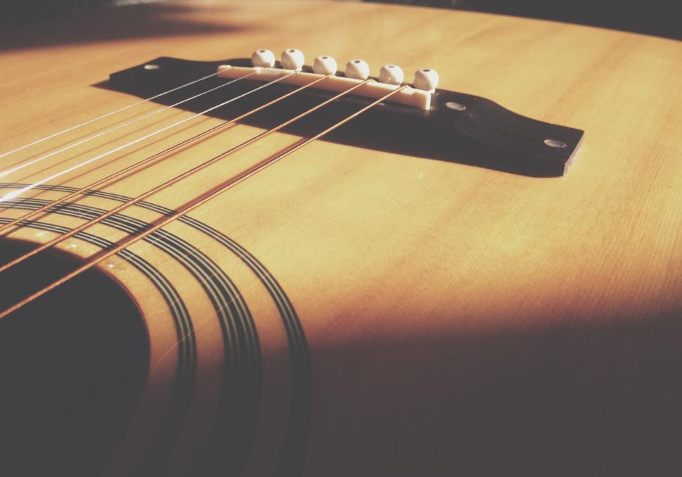 Free Image of Close-up of guitar bridge and strings 