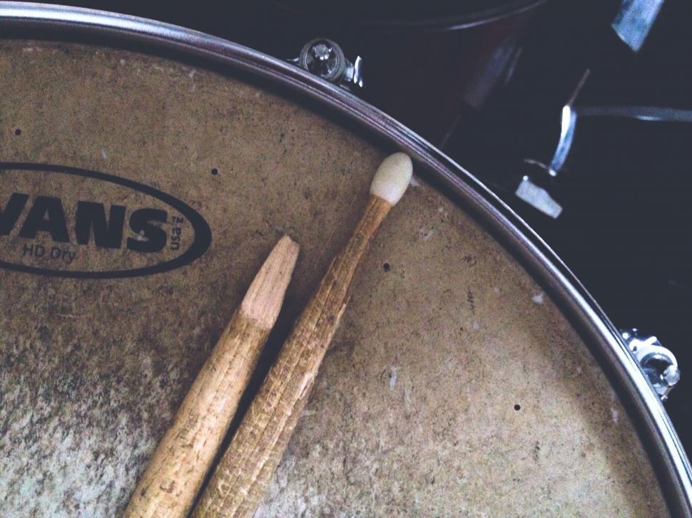 Free Image of Drum with drumsticks and brand logo 