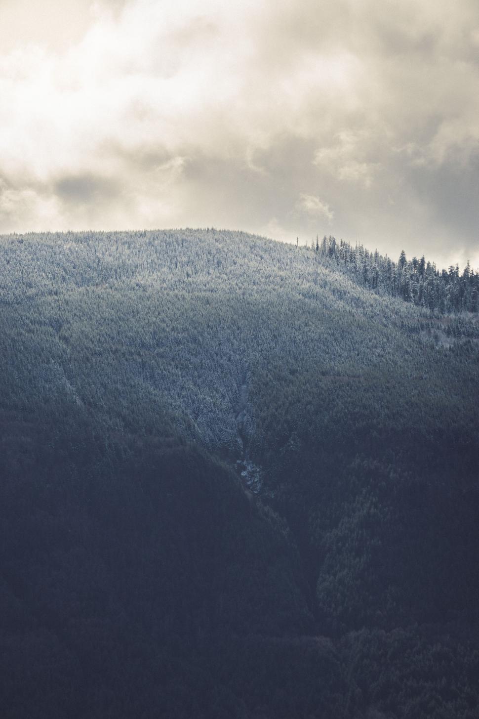 Free Image of Moody Mountain Top with Light Snow 