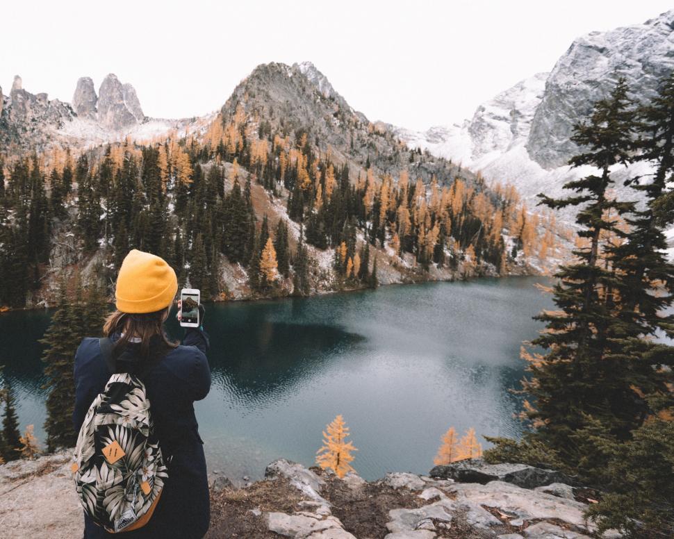 Free Image of Person capturing autumn mountain scenery 